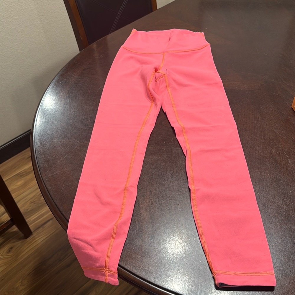 Lululemon Neon coral reversible (gray other side) crop length leggings.